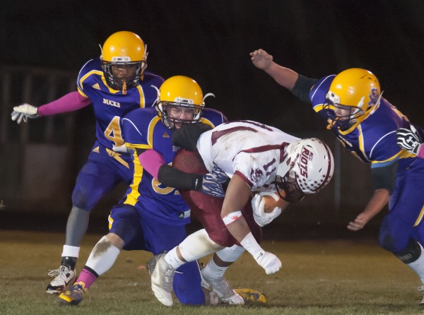 Orono running back Christian Mowrer (11) gets tackled by Bucksport defensive back Asher Bowden (31) in the first half in Bucksport, Maine, Friday, Nov. 8, 2013. Orono running back Christian Mowrer (11) gets tackled by Bucksport defensive back Asher Bowden (31) in the first half in Bucksport, Maine, Friday, Nov. 8, 2013.