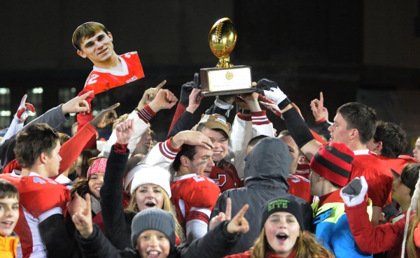Cony High School football players carry the Class B state football championship trophy into the crowd of fans waiting at the end of the field at Alfond Stadium on Friday after defeating Kennebunk 30-23. Cony High School football players carry the Class B state football championship trophy into the crowd of fans waiting at the end of the field at Alfond Stadium on Friday after defeating Kennebunk 30-23.