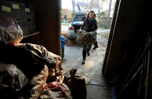 Elsie Gawler, co-owner of North Branch Farm in Monroe, carries bags of onions into the basement of Food AND Medicine in Brewer in preparation for the 11th Annual Solidarity Harvest, which expects to distribute more than 1,000 Thanksgiving baskets for families in hard times. Elsie Gawler, co-owner of North Branch Farm in Monroe, carries bags of onions into the basement of Food AND Medicine in Brewer in preparation for the 11th Annual Solidarity Harvest, which expects to distribute more than 1,000 Thanksgiving baskets for families in hard times.