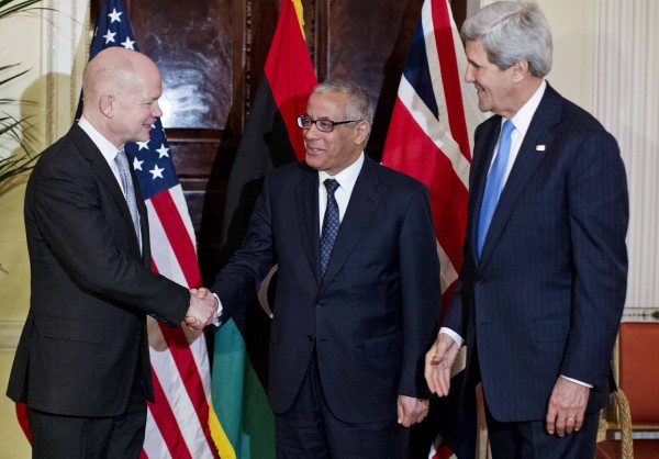 U.S. Secretary of State John Kerry (right) watches as British Foreign Secretary William Hague (left) shakes hands with Libyan Prime Minister Ali Zeidan at Winfield House, the residence of the U.S. Ambassador to Britain, in London, Nov. 24, 2013. U.S. Secretary of State John Kerry (right) watches as British Foreign Secretary William Hague (left) shakes hands with Libyan Prime Minister Ali Zeidan at Winfield House, the residence of the U.S. Ambassador to Britain, in London, Nov. 24, 2013.