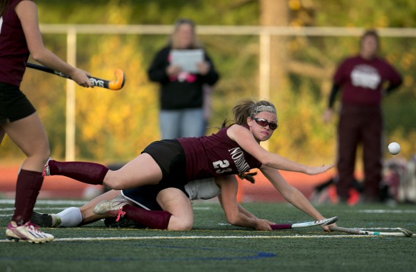 Nokomis' Taylor Shaw tumbles over York's Taylor Simpson in the first half of the Class B field hockey state championship game Saturday, Nov. 2, 2013, in Yarmouth, Maine. Nokomis' Taylor Shaw tumbles over York's Taylor Simpson in the first half of the Class B field hockey state championship game Saturday, Nov. 2, 2013, in Yarmouth, Maine.