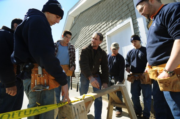 Mark Martin, center, instructor at the Home Builders Institute on the Penobscot Job Corp campus draws a sketch on a saw horse to show his students the next step in laying out a building in the parking lot of the center on Thursday, April 7, 2011. Mark Martin, center, instructor at the Home Builders Institute on the Penobscot Job Corp campus draws a sketch on a saw horse to show his students the next step in laying out a building in the parking lot of the center on Thursday, April 7, 2011.