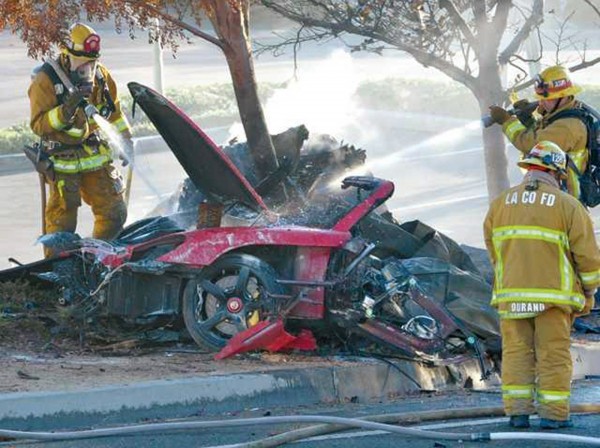 Firefighters extinguish the fire in the car where actor Paul Walker was killed along with Roger Rodas during a car crash in Valencia, Santa Clarita, Calif., Nov. 30, 2013. Firefighters extinguish the fire in the car where actor Paul Walker was killed along with Roger Rodas during a car crash in Valencia, Santa Clarita, Calif., Nov. 30, 2013.