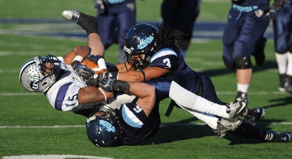 UMaine's Sherrod Baltimore and Troy Eastman bring down UNH's R.J. Harris as he carries the ball against UMaine at Orono during first half action on Saturday. UMaine's Sherrod Baltimore and Troy Eastman bring down UNH's R.J. Harris as he carries the ball against UMaine at Orono during first half action on Saturday.