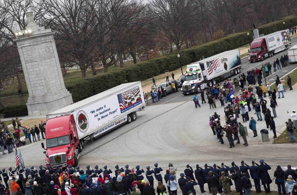 Trucks arrive carrying wreaths during the annual Wreaths Across America event at Arlington National Cemetery in Washington on Saturday. Volunteers and families of the fallen placed thousands of remembrance wreaths on headstones throughout the cemetery on National Wreaths Across America Day. Trucks arrive carrying wreaths during the annual Wreaths Across America event at Arlington National Cemetery in Washington on Saturday. Volunteers and families of the fallen placed thousands of remembrance wreaths on headstones throughout the cemetery on National Wreaths Across America Day.