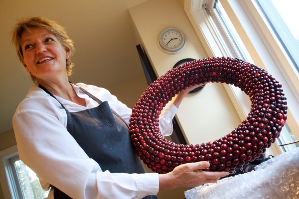 Freeport artist Deena Prestegard holds one of her cranberry wreath creations in her kitchen, where she makes them. Freeport artist Deena Prestegard holds one of her cranberry wreath creations in her kitchen, where she makes them.