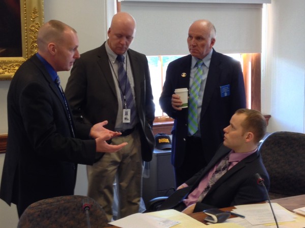 Lt. Scott Ireland (left) of the Maine State Police talks to Reps. Timothy Marks (from left), D-Pittston, Thomas Tyler, R-Windham, and Corey Wilson, R-Augusta, during a break in a subcommittee hearing on Maine concealed handgun permits at the State House in Augusta on Wednesday, Dec. 11. Lt. Scott Ireland (left) of the Maine State Police talks to Reps. Timothy Marks (from left), D-Pittston, Thomas Tyler, R-Windham, and Corey Wilson, R-Augusta, during a break in a subcommittee hearing on Maine concealed handgun permits at the State House in Augusta on Wednesday, Dec. 11.