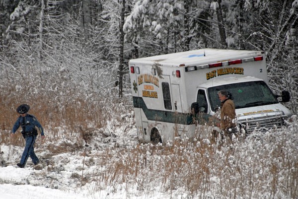 Maine State Police Trooper Trevor Snow walks away from an East Millinocket-Lincoln ambulance that rolled over while heading south on Interstate 95 on Monday. Maine State Police Trooper Trevor Snow walks away from an East Millinocket-Lincoln ambulance that rolled over while heading south on Interstate 95 on Monday.