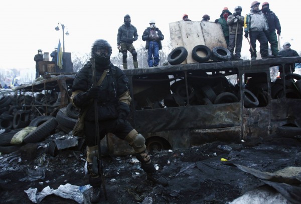 Anti-government protesters look out from barricades at the site of clashes with police in Kiev, January 27, 2014. Police clashed with protesters in central Kiev on Sunday and the fate of Ukraine's government was uncertain after embattled President Viktor Yanukovich offered important posts to opposition leaders, including the role of prime minister. Anti-government protesters look out from barricades at the site of clashes with police in Kiev, January 27, 2014. Police clashed with protesters in central Kiev on Sunday and the fate of Ukraine's government was uncertain after embattled President Viktor Yanukovich offered important posts to opposition leaders, including the role of prime minister.