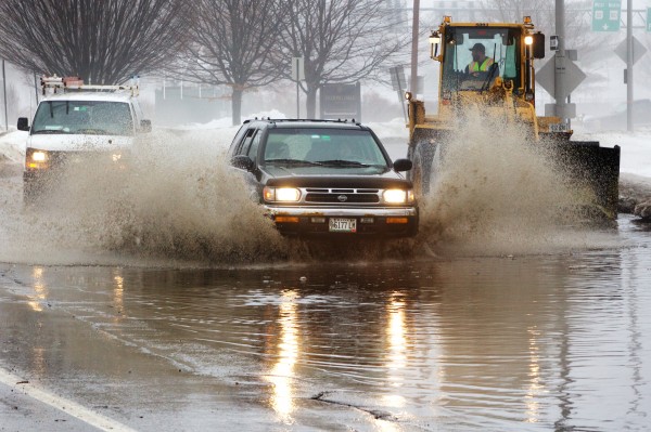 An SUV dashes through a flooded section of State Street in Portland Monday as workmen attempt to clear the storm drains. An SUV dashes through a flooded section of State Street in Portland Monday as workmen attempt to clear the storm drains.