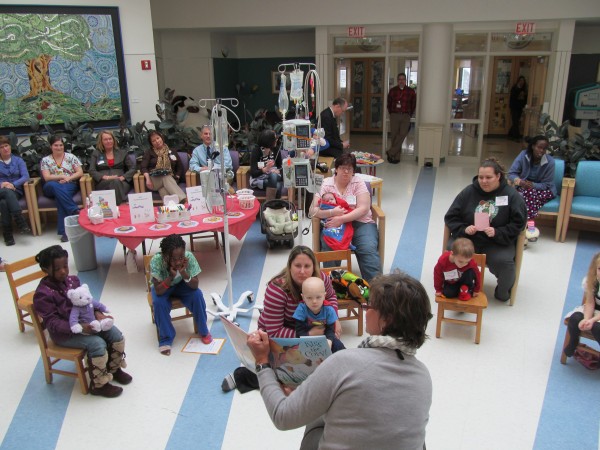 Abigail Snyder, a teacher at Barbara Bush Children's Hospital at Maine Medical Center in Portland, reads a book to a group of children gathered Friday morning for a kick-off event for the organization Raising Readers, which urged parents to resolve in the new year to encourage their children to read. Abigail Snyder, a teacher at Barbara Bush Children's Hospital at Maine Medical Center in Portland, reads a book to a group of children gathered Friday morning for a kick-off event for the organization Raising Readers, which urged parents to resolve in the new year to encourage their children to read.