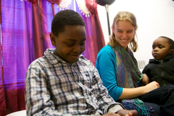 Bethany Dixon (center) smiles at Rafiki Nsabimana, 8, (left) and his brother Miraji, 3, Monday in their apartment in Portland. Dixon was placed with the Nsabimana family through an intensive college program. Bethany Dixon (center) smiles at Rafiki Nsabimana, 8, (left) and his brother Miraji, 3, Monday in their apartment in Portland. Dixon was placed with the Nsabimana family through an intensive college program.
