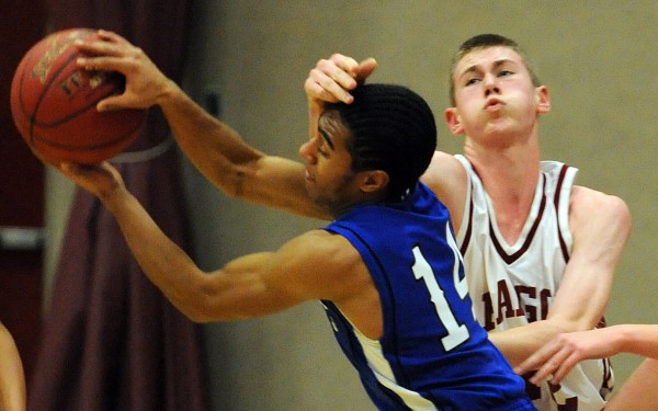 Bangor's Justin Smith gets a hand on Lewiston's Ben Howell while rebounding during first-quarter action on Friday night at Red Barry Gym in Bangor. Bangor's Justin Smith gets a hand on Lewiston's Ben Howell while rebounding during first-quarter action on Friday night at Red Barry Gym in Bangor.
