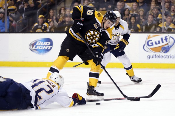 Boston Bruins right wing Reilly Smith (18) slides the puck away from Nashville Predators defenseman Mattias Ekholm (42) during the third period at TD Banknorth Garden in Boston Thursday night. The Bruins won 3-2 in overtime. Boston Bruins right wing Reilly Smith (18) slides the puck away from Nashville Predators defenseman Mattias Ekholm (42) during the third period at TD Banknorth Garden in Boston Thursday night. The Bruins won 3-2 in overtime.