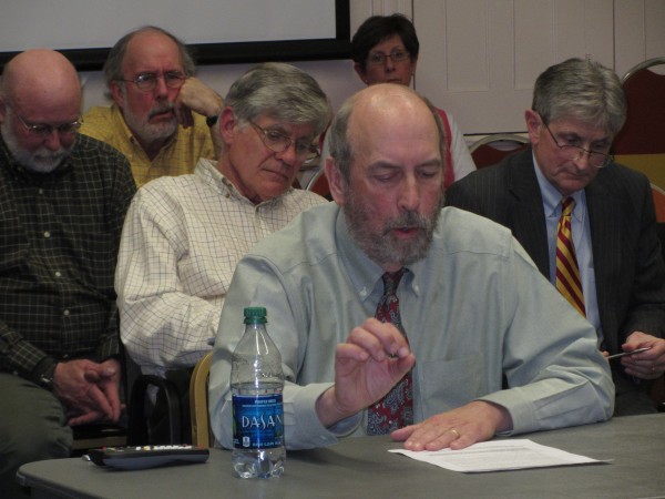 Regional School Unit 13 Superintendent Lew Collins explains Tuesday night the reasons he is recommending the firing of business manager Scott Vaitones, sitting behind Collins in a white shirt. Regional School Unit 13 Superintendent Lew Collins explains Tuesday night the reasons he is recommending the firing of business manager Scott Vaitones, sitting behind Collins in a white shirt.