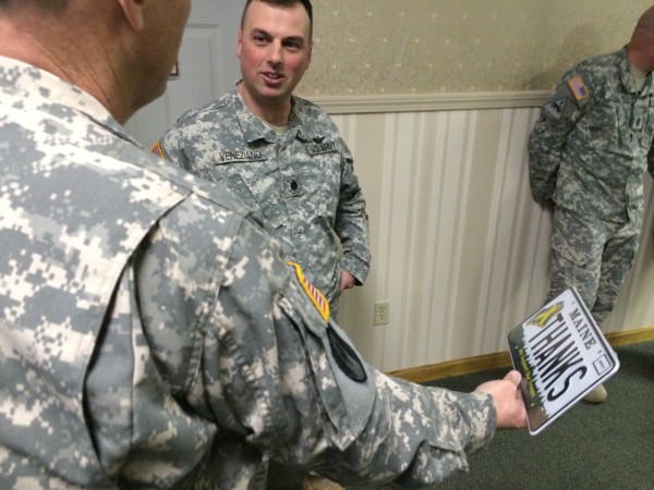 Commander Ron Ireland, a Chief Warrant Officer 5, who just completed his fifth deployment leading eight members of Detachment 14, Operational Support Airlift Command in Afghanistan, shows off a special license plate that says, "Thanks" given to him by Brewer veteran and troop greeter Charles "Dusty" Fisher (not pictured) to Lt. Col. Brian Veneziano, the State Aviation Officer. "We're going to have to find a place to display this," Ireland said. Commander Ron Ireland, a Chief Warrant Officer 5, who just completed his fifth deployment leading eight members of Detachment 14, Operational Support Airlift Command in Afghanistan, shows off a special license plate that says, "Thanks" given to him by Brewer veteran and troop greeter Charles "Dusty" Fisher (not pictured) to Lt. Col. Brian Veneziano, the State Aviation Officer. "We're going to have to find a place to display this," Ireland said.