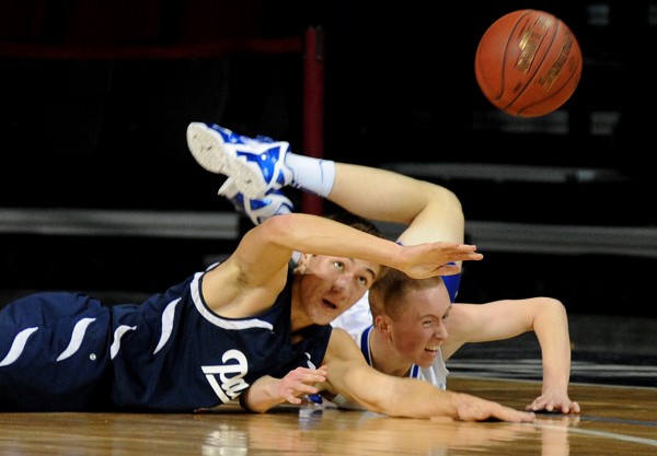 Bangor Christian's Ben Miller (left) passes the ball after getting tripped up with Easton's Drew Sotomayor in first-half action of Saturday night's Class D quarterfinal basketball game at the Cross Insurance Center. Easton won 41-37. Bangor Christian's Ben Miller (left) passes the ball after getting tripped up with Easton's Drew Sotomayor in first-half action of Saturday night's Class D quarterfinal basketball game at the Cross Insurance Center. Easton won 41-37.