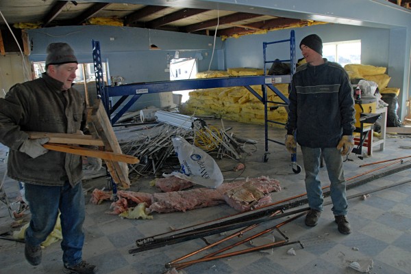 James Bernadini and Jamis Trothier chat as they work on recycling and razing The Hamlet building at 117 Main St. in East Millinocket on Friday. Building owner and Selectman Clint Linscott said the recent layoff at the town paper mill finally forced him after years of pondering to start razing buildings he owns in town. James Bernadini and Jamis Trothier chat as they work on recycling and razing The Hamlet building at 117 Main St. in East Millinocket on Friday. Building owner and Selectman Clint Linscott said the recent layoff at the town paper mill finally forced him after years of pondering to start razing buildings he owns in town.