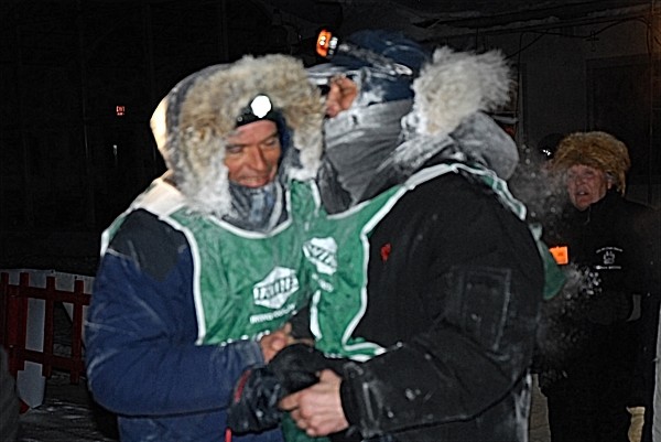 This year's Can Am winner Martin Massicotte (right) and second-place finisher Andre Longchamps at the finish line in Fort Kent Monday morning. This year's Can Am winner Martin Massicotte (right) and second-place finisher Andre Longchamps at the finish line in Fort Kent Monday morning.
