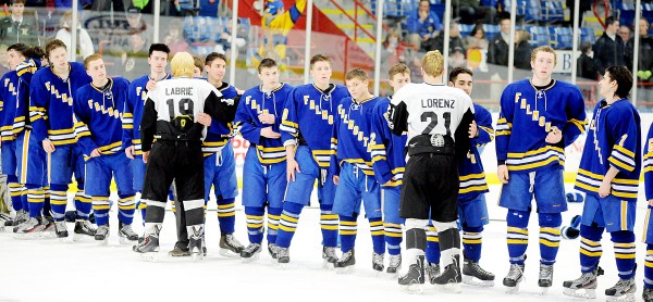 Saint Dominic players Caleb Labrie (19) and Mitch Lorenz (21) congratulate Falmouth players during the awards ceremony on Saturday after Falmouth won the Class A state final 3-2 in Lewiston. Saint Dominic players Caleb Labrie (19) and Mitch Lorenz (21) congratulate Falmouth players during the awards ceremony on Saturday after Falmouth won the Class A state final 3-2 in Lewiston.
