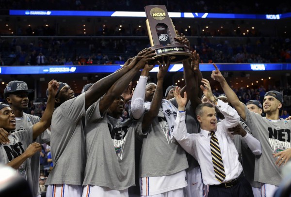 The Florida Gators celebrate with the trophy with head coach Billy Donovan after defeating the Dayton Flyers 62-52 in the South Regional final of the NCAA Tourney Saturday night at FedExForum in Memphis. The Florida Gators celebrate with the trophy with head coach Billy Donovan after defeating the Dayton Flyers 62-52 in the South Regional final of the NCAA Tourney Saturday night at FedExForum in Memphis.