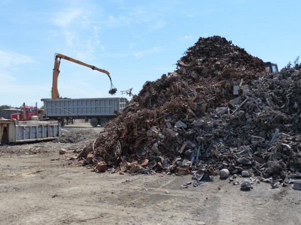 In this March 2013 file photo, waste sits in piles at ecomaine's southern Maine landfill while a magnet on a crane pulls metals from the processed refuse in the background. In this March 2013 file photo, waste sits in piles at ecomaine's southern Maine landfill while a magnet on a crane pulls metals from the processed refuse in the background.