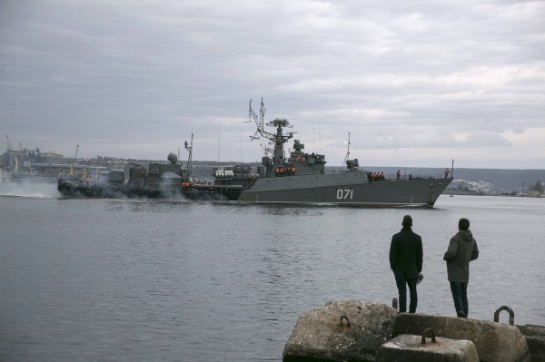 People watch a Russian Navy ship enter the Crimean port city of Sevastopol on Sunday, March 2, 2014. People watch a Russian Navy ship enter the Crimean port city of Sevastopol on Sunday, March 2, 2014.