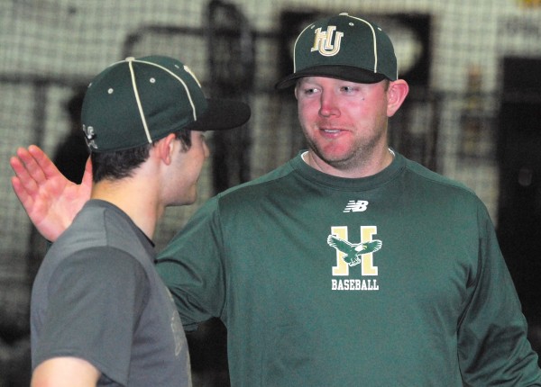 Husson University baseball coach Jason Harvey greets team member Nate Stewart during practice at Sluggers in Brewer on Wednesday night. Husson University baseball coach Jason Harvey greets team member Nate Stewart during practice at Sluggers in Brewer on Wednesday night.