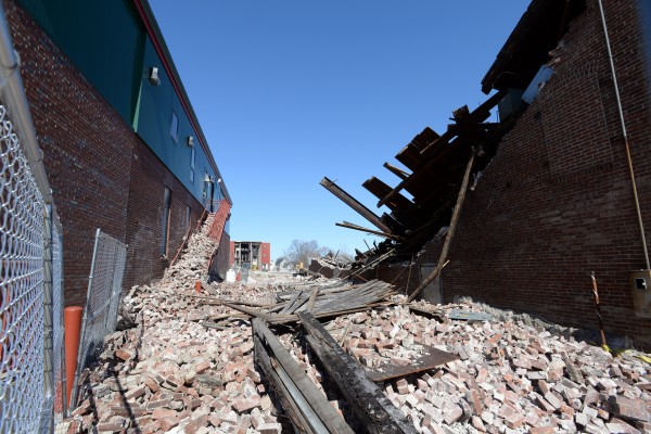 While bringing down the Old Town Canoe building (at right), the structure crashed into the Old Town Fire Department wrecking the fire escape stairs, breaking two windows, and cracking the wall in several areas. While bringing down the Old Town Canoe building (at right), the structure crashed into the Old Town Fire Department wrecking the fire escape stairs, breaking two windows, and cracking the wall in several areas.
