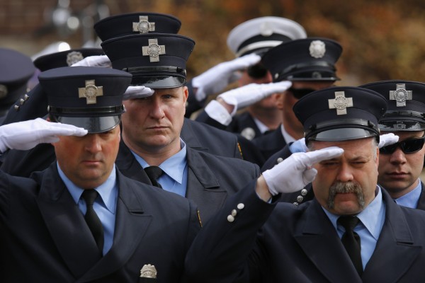 Firefighters salute during the funeral procession for Boston Fire Department Lt. Edward Walsh outside Saint Patrick's Church in Watertown, Mass., April 2, 2014. Firefighters salute during the funeral procession for Boston Fire Department Lt. Edward Walsh outside Saint Patrick's Church in Watertown, Mass., April 2, 2014.
