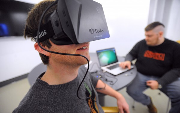Lucas Richards (left) and Ian Lusk, new media majors at the University of Maine, use the new Oculus Rift virtual reality headset in their senior project Wednesday. Lucas Richards (left) and Ian Lusk, new media majors at the University of Maine, use the new Oculus Rift virtual reality headset in their senior project Wednesday.