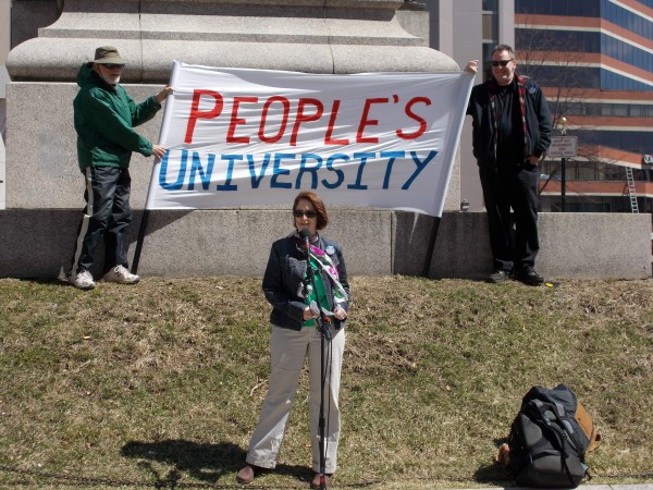 Meghan Brodie, Ph. D. speaks at the rally for #USMFuture and #UMaineFuture in downtown Portland on Thursday, April 9. Photo by Chris Shorr, BDN.