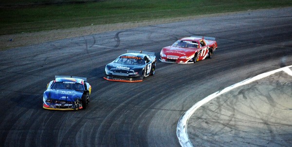 Austin Theriault, center, and Travis Benjamin battle (17) it out for the lead in lap 150 of the Oxford 250 Sunday. Benjamin went on to claim his second straight Oxford 250 victory. Austin Theriault, center, and Travis Benjamin battle (17) it out for the lead in lap 150 of the Oxford 250 Sunday. Benjamin went on to claim his second straight Oxford 250 victory.