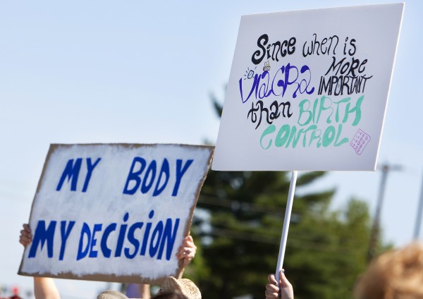 Protestors hold up signs during a protest against the recent Supreme Court decision about birth control on Saturday outside the Bangor Hobby Lobby. Protestors hold up signs during a protest against the recent Supreme Court decision about birth control on Saturday outside the Bangor Hobby Lobby.