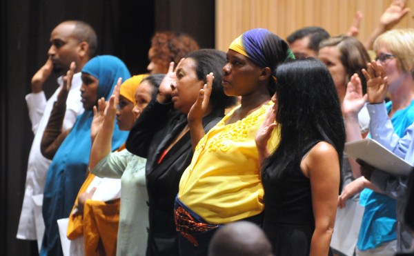 People take the Oath of Allegiance during a naturalization ceremony at the Gracie Theater at Husson University on Thursday. People take the Oath of Allegiance during a naturalization ceremony at the Gracie Theater at Husson University on Thursday.