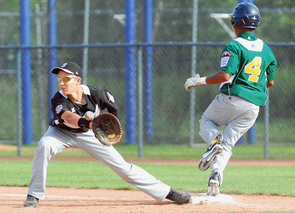 Connecticut first baseman Brad Burney gloves a throw but not before Latin America's Mairion Brunken safely reaches during Senior League World Series action at Mansfield Stadium in Bangor Tuesday afternoon. Connecticut first baseman Brad Burney gloves a throw but not before Latin America's Mairion Brunken safely reaches during Senior League World Series action at Mansfield Stadium in Bangor Tuesday afternoon.