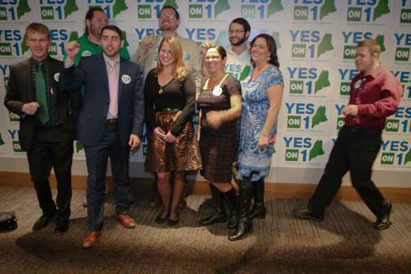 Supporters and organizers chant and pose for a photo at the Yes on 1 campaign party in Tuesday night in Portland. 