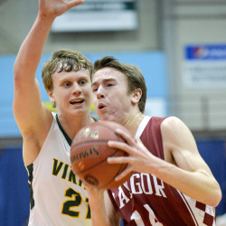 Bangor’s George Payne (right) takes the ball to the basket while guarded by Oxford Hills’ Trevor Goodrich during a game last season. Payne is a senior guard for the Rams this season.