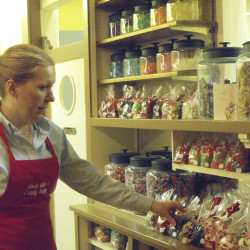 Karen Keber Sutton, proprietor of Uncle Willy's Candy Shoppe in Houlton, stocks shelves at her Main Street store in this Dec. 2009 photo. The store is closing on Saturday.