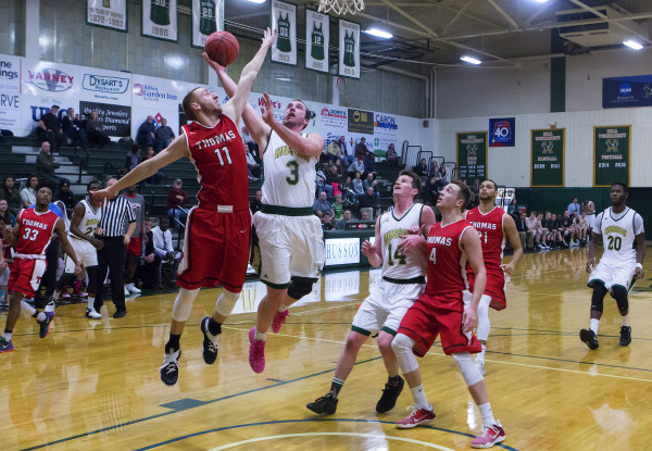 Husson University's Eli Itkin (center) tries for two past Thomas College's Jordan Greenleaf during their basketball game at Newman Gym in Bangor Tuesday. Husson University's Eli Itkin (center) tries for two past Thomas College's Jordan Greenleaf during their basketball game at Newman Gym in Bangor Tuesday.