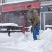 Blaze maintenance man Robert McClure tries to keep on top of the falling snow so there's a clear path to the business on Monday afternoon in Bangor.