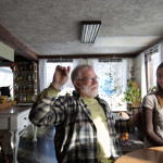 Stephen DeGoosh and Brooke Isham talk in the living and dining area of their home. Forty years ago, a retired Air Force captain and his family built the bunker-like home on a stake of land in rural Sangerville and prepared for the worst. Now DeGoosh and Isham are staying true to the original plans of the home -- a large garden, a greenhouse -- but with transition and food sovereignty in mind instead of survivalism.