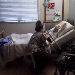 Salena Sawtelle, a certified nursing assistant at the Stillwater Health Care nursing home in Bangor, talks to Connie Drake before getting her ready for breakfast on Feb. 28