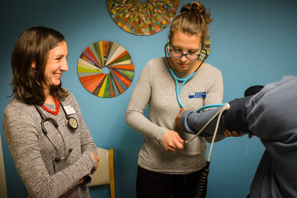 Nursing student Courtney Wilson checks a patient's blood pressure under the watchful eye of nurse practitioner Gretchen Speed at the Greater Portland Health clinic on May 9. Wilson is graduating this month from the University of New England's accelerated nursing program. Nursing student Courtney Wilson checks a patient's blood pressure under the watchful eye of nurse practitioner Gretchen Speed at the Greater Portland Health clinic on May 9. Wilson is graduating this month from the University of New England's accelerated nursing program.