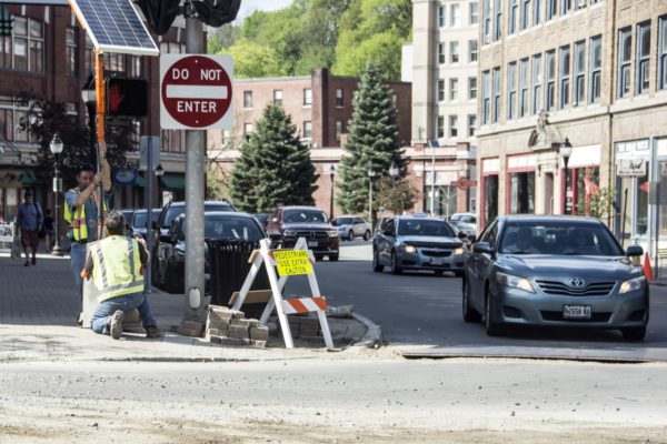 City workers set up a temporary crosswalk sign at Hammond and Central streets in downtown Bangor on Thursday. Businesses there say construction work being done is hampering some sales, but that it's necessary. City workers set up a temporary crosswalk sign at Hammond and Central streets in downtown Bangor on Thursday. Businesses there say construction work being done is hampering some sales, but that it's necessary.