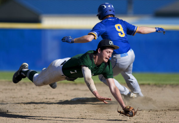 Old Town's Ryan Hoogterp (left) dives to grab a wild throw to second, allowing Hermon's Matt Leach to be safe during their game in Hermon on Friday. Old Town's Ryan Hoogterp (left) dives to grab a wild throw to second, allowing Hermon's Matt Leach to be safe during their game in Hermon on Friday.