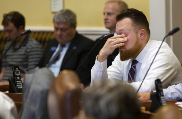 Sen. Garrett Mason, R-Lisbon Falls, puts his hands to his face while listening to arguments during the Senate's hearing on the state budget at the Maine State House in Augusta.