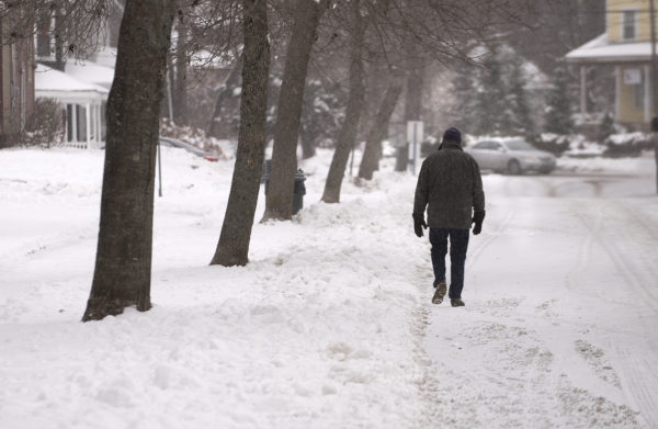 Gabor Degre | BDN
Gabor Degre | BDN A man walks on the snow-covered road in Bangor Dec. 12 2017