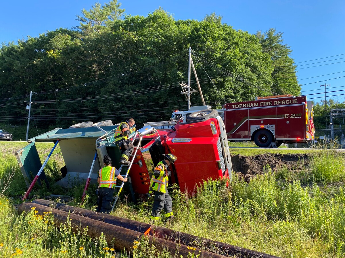 Dump truck and SUV roll over after Topsham collision